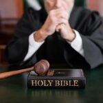 Supreme Court Showdown Looms Over Ten Commandments A judge in a courtroom with a gavel and a Holy Bible on the table