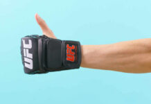 Thumbs up with UFC gloves, blue background.