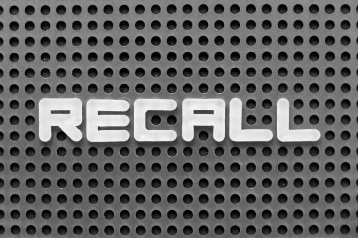 shutterstock_2287229791.jpg The word 'RECALL' displayed on a perforated surface