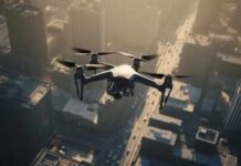 A drone flying over a cityscape during sunset