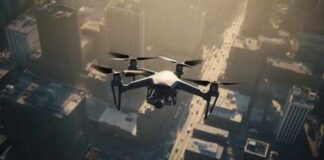 A drone flying over a cityscape during sunset