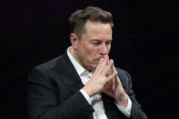shutterstock_2318800313-1.jpg Elon Musk in a suit deep in thought, black background.