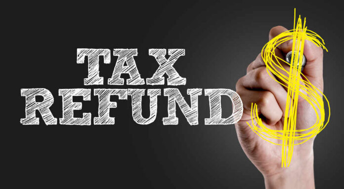 shutterstock_399497785.jpg Hand writing 'TAX REFUND' with a dollar sign