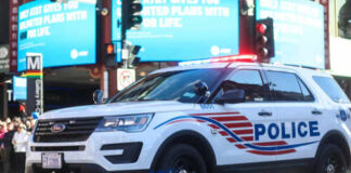Police SUV with lights on in an urban environment