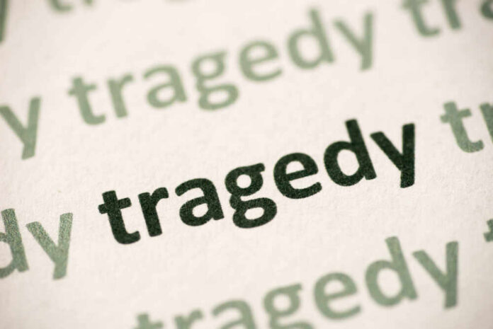 Close-up of the word 'tragedy' printed multiple times in varying shades