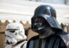 DISNEY’S STAR WARS FLOPS – Franchise in Trouble? Darth Vader and stormtrooper in costume at event.