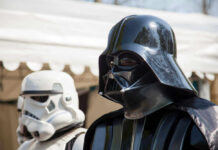DISNEY’S STAR WARS FLOPS – Franchise in Trouble? Darth Vader and stormtrooper in costume at event.