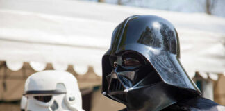 Darth Vader and stormtrooper in costume at event.