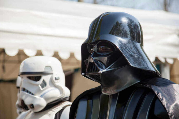 Darth Vader and stormtrooper in costume at event.