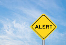 Chocolate CONTAMINATED — Source Still Unknown Yellow alert sign against a blue sky