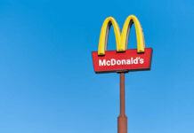 McDonald’s KILLING Beloved Feature McDonald's restaurant sign against a clear blue sky
