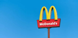 McDonald's restaurant sign against a clear blue sky