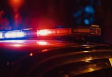 Agent Assaulted — Trump Golf Club Security Incident Close-up of a police car's emergency lights at night