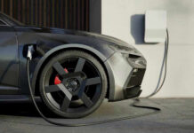 EV Shocker: Shares Tumble 8%! Electric car charging at a station.
