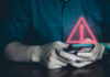 Caller ID Lies: The New Bank Heist Person holding phone with warning symbol displayed.