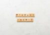 Wooden letter tiles spelling 'Product recall' on a textured surface