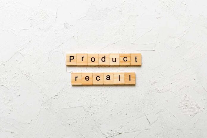 shutterstock_2450452315.jpg Wooden letter tiles spelling 'Product recall' on a textured surface