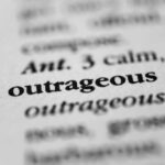 Election Denier’s Sentence Halved – Outrage Erupts! Close-up of a dictionary entry highlighting the word 'outrageous'