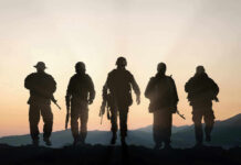 SHOCK Troop U-Turn: Allies BLINDSIDED!? Five armed soldiers silhouetted against sunset background.