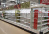 Empty supermarket shelves with great prices signage