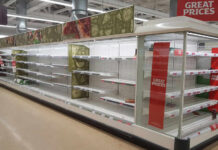 Empty supermarket shelves with great prices signage