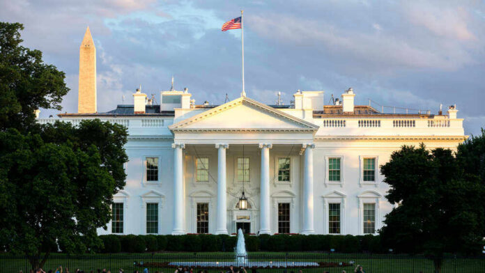 shutterstock_1819595129 The White House with Washington Monument in background.