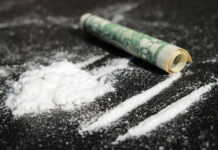 Drug Boat Hit Cocaine lines with rolled banknote on surface