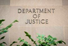 DOJ Silence Ignites Newsom Firestorm Department of Justice building wall with engraved lettering