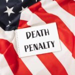Death Penalty Looms — Courtroom Thrown Open Notebook with message on an American flag background
