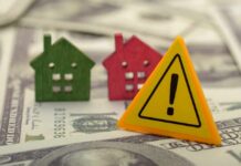 Capped Homes, Soaring Rents? Colorful house models and a warning sign on dollar bills