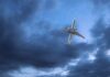 An airplane flying through a cloudy sky