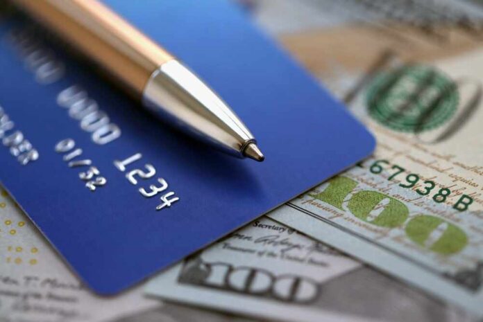 One,Hundred,Us,Dollar,Bills,And,Silver,Pen,With,Blue