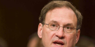 Samuel Alito speaking into a microphone.