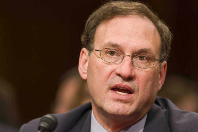 shutterstock_387755479 Samuel Alito speaking into a microphone.
