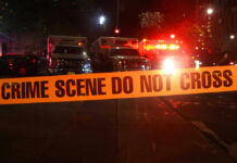 VIDEO: Standoff Ends — He’s Dead! Crime scene tape with emergency vehicles in background.
