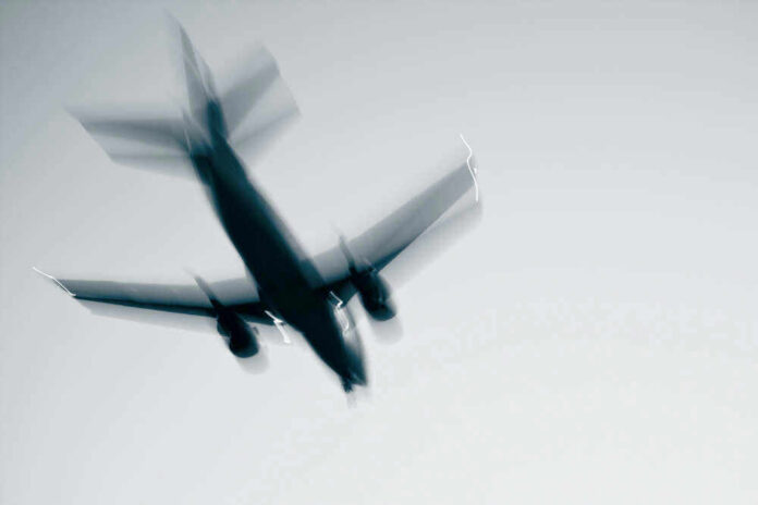 shutterstock_87563047 Airplane in flight with motion blur.