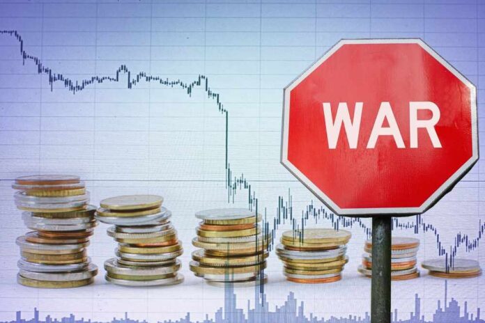 War,Sign,On,Economy,Background,-,Graph,And,Coins.,Economic A stop sign with the word 'WAR' in front of a declining stock market graph and stacks of coins