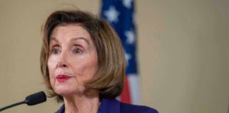 Nancy Pelosi speaking at podium.