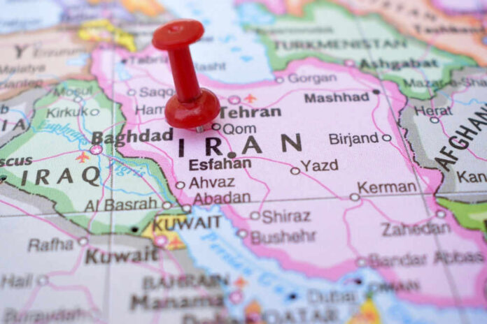 shutterstock_2237379503 Red pushpin on map of Iran
