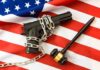 Gun Rights On The Brink A handgun chained on an American flag with a gavel beside it