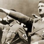 Austria’s Bold Move: Hitler House Reborn man giving a raised-arm salute at a rally