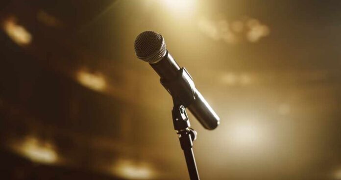 Close,Up,Of,A,Microphone,At,A,Night,Concert.,Music Close-up of a microphone on a stage with soft lighting