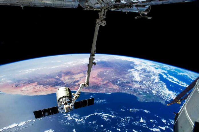 The,International,Space,Station's,Canadarm2,Prepares,To,Release,The,Orbital View of Earth from the International Space Station with a satellite in focus