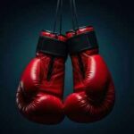 Road Rage Horror Stuns Boxing World A pair of red boxing gloves hanging against a dark background