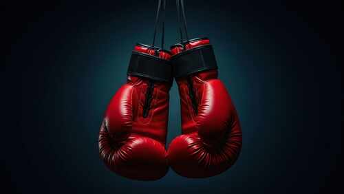 Hanging,Red,Boxing,Gloves,Against,A,Dark,Blue,Backdrop,,Symbolizing A pair of red boxing gloves hanging against a dark background