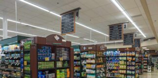 Interior view of a grocery store aisle with shelves of food and beverages