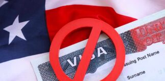 A red 'no' symbol over a visa document on an American flag background