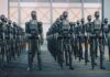 A row of humanoid robots standing in an industrial space