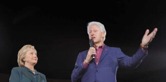 Hillary Clinton and Bill Clinton speaking at a political rally