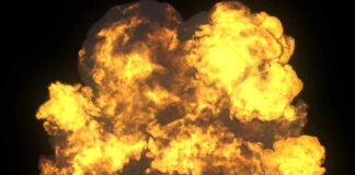 A large explosion with flames and smoke against a dark background